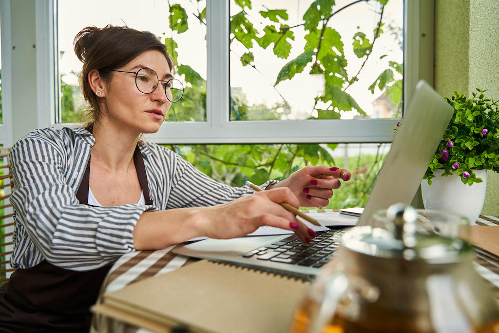 business owner working on laptop while doing year-end tax planning.