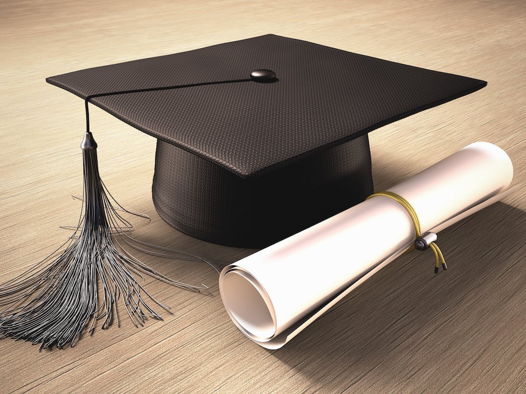 graduate hat and diploma representing education-related tax incentives as part of year-end tax planning.