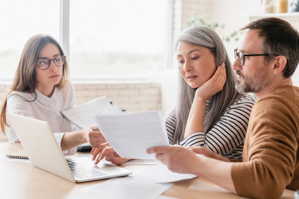 Clients meeting with tax professional while they discuss the details related to hiring a tax professional.