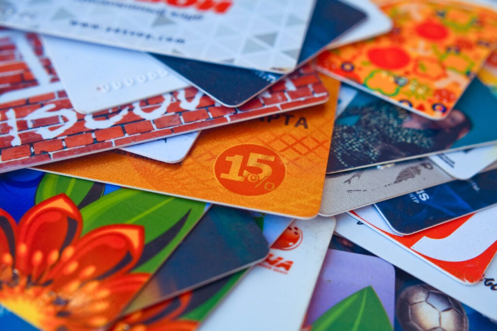 bright plastic discount cards closeup. market background. selective focus.