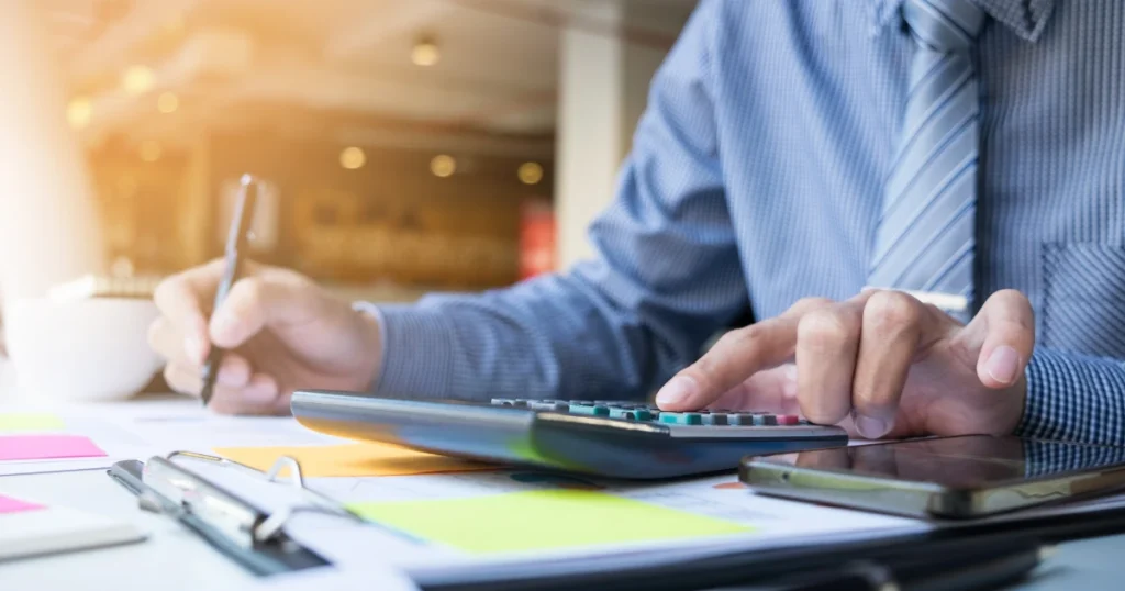 Business owner reviewing an accounts receivable aging report at a desk